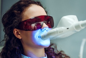 woman in dental chair having whitening treatment