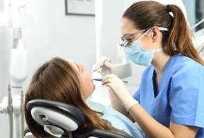 dentist examining woman’s mouth