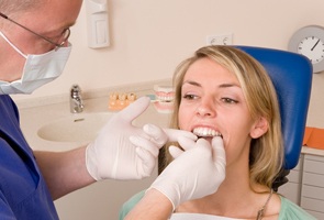 A dentist placing clear braces for a patient