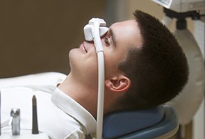 man lying down with nitrous oxide mask over his nose 