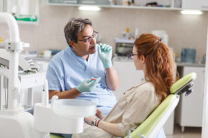 Dentist talking to patient about dental care