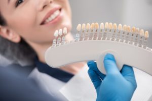 Veneers held up to woman's smile