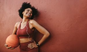 Girl with basketball smiles while wearing Invisalign in Wharton